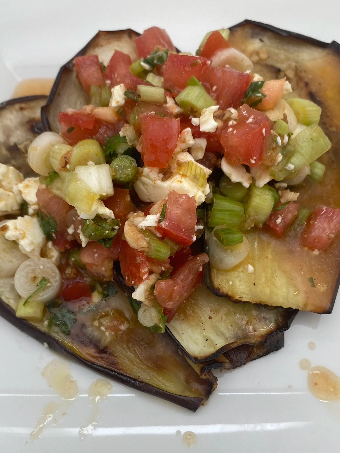 Grilled eggplant with a garlic-cumin and feta dressing
